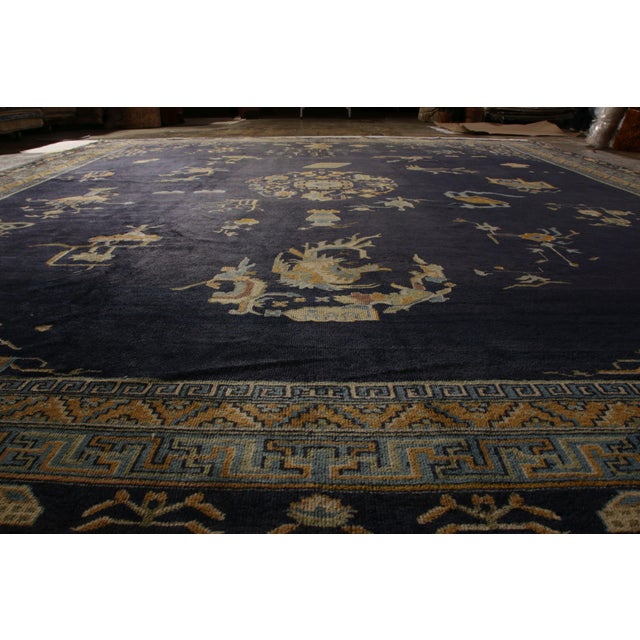 Hand-knotted in wool originating from East Turkestan circa 1920, this antique art deco rug connotes a Samarkand rug...