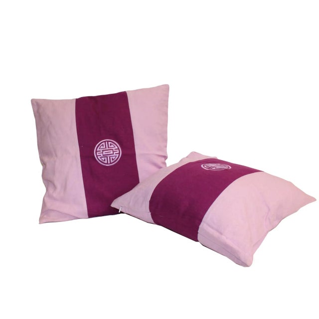 This is a pair of square shape pillow cushions. It has a purple color mix with a graphic fabric cover - with a zipper....