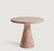 This minimalist table is crafted from Red Travertine showcasing a circular tabletop that balances securely and...