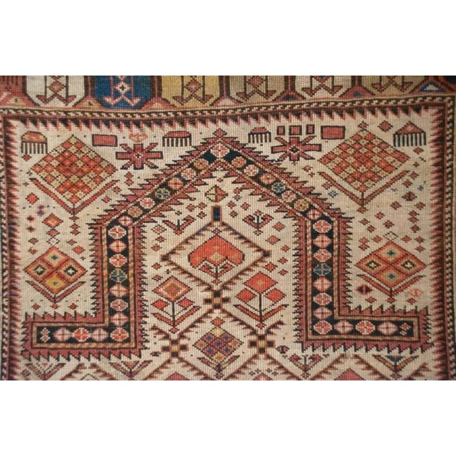 An outstanding mid-19th century Persian Shirvan prayer rug with an incredible stylized multicolored floral pattern field...