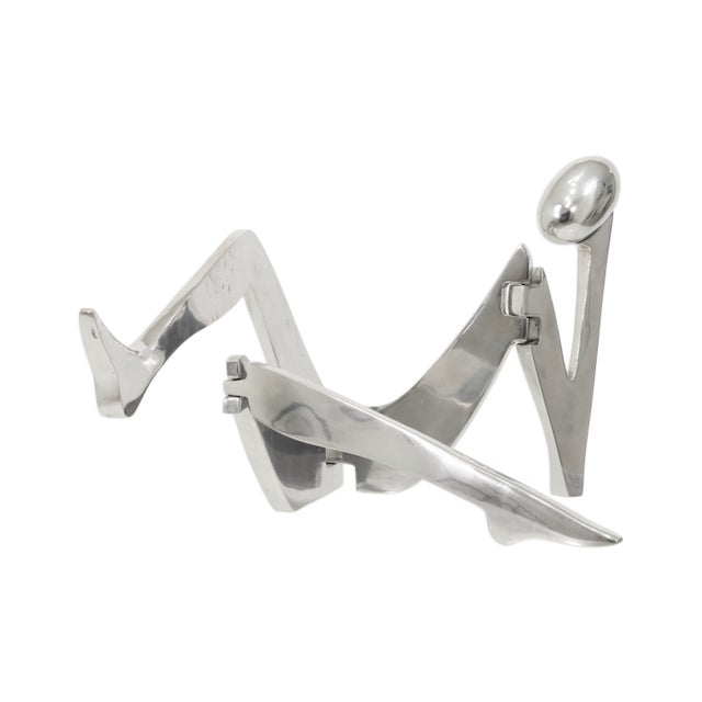 This articulated polished aluminum sculpture by Eichengreen & Ginsburg presents a sleek and playful interpretation of the...