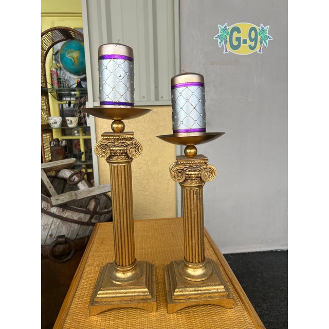 Pair of gold candlestick holders. Vintage Neoclassical style Gold gilded in gold. The tall Corithian Column Pillar...
