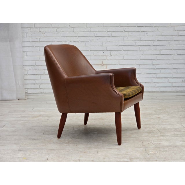 1970s, Danish armchair. Brown artificial leather, teak wood legs, seat cushion in furniture wool. Original good condition:...