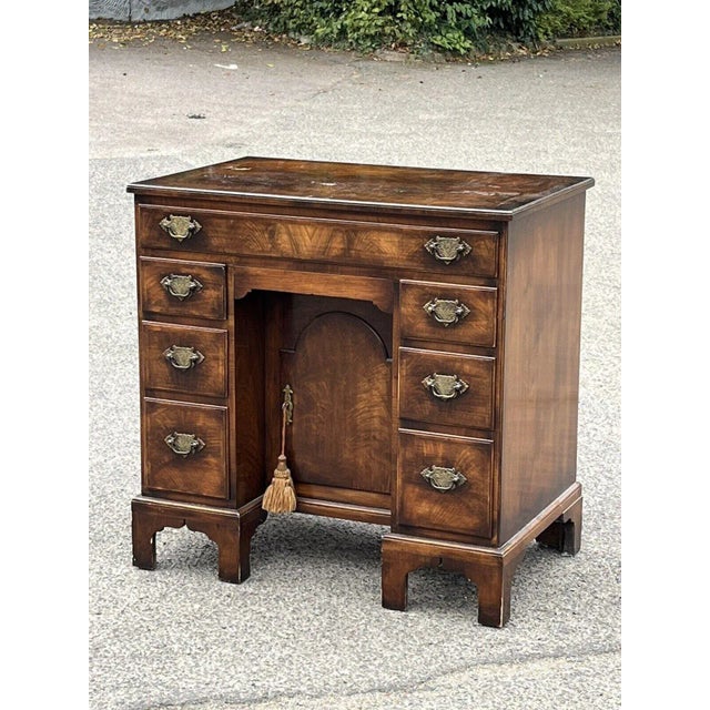 Burr walnut kneehole desk. 7 drawers plus a secret drawer and a cupboard to centre. Brass handles. This is an old used...