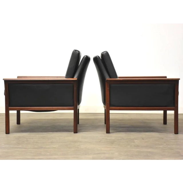 A modern set of lounge chairs with a sculpted rosewood frame designed by Knut Saeter for Vatne Möbler. 30.5” wide 30.25”...