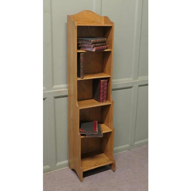 Arts and Crafts Tall Slim Golden Oak Bookcase. This Oak bookcase has 6 open shelves in a waterfall with an arched gallery...