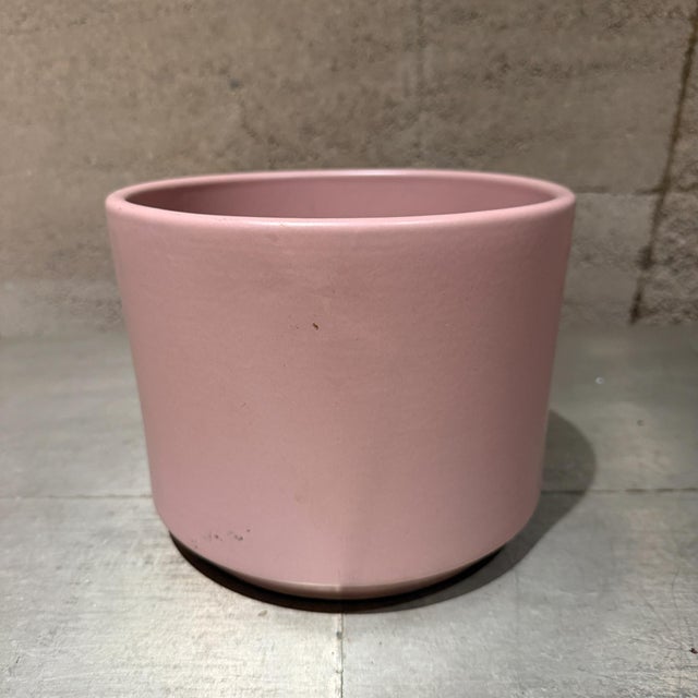 For your consideration, a minimalist ceramic cylinder plant pot featuring a matte pastel pink glaze. Produced by Gainey....