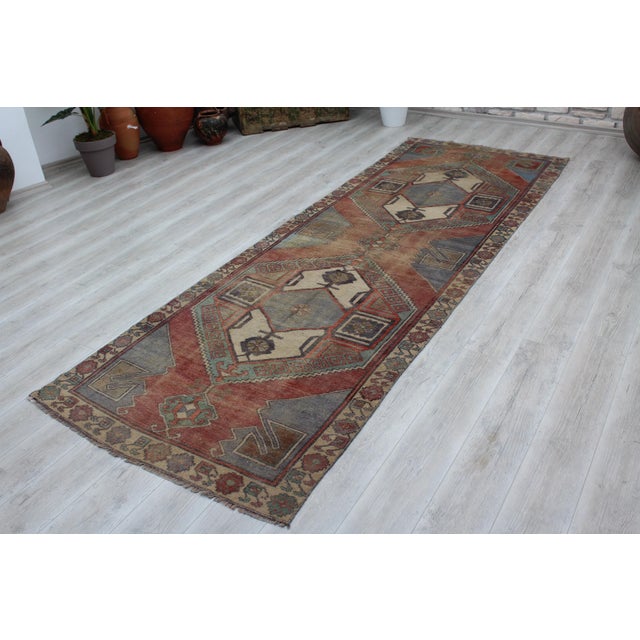 This gorgeous hand knotted Vintage Anatolian runner rug is approximately 60 years old in excellent vintage condition. The...