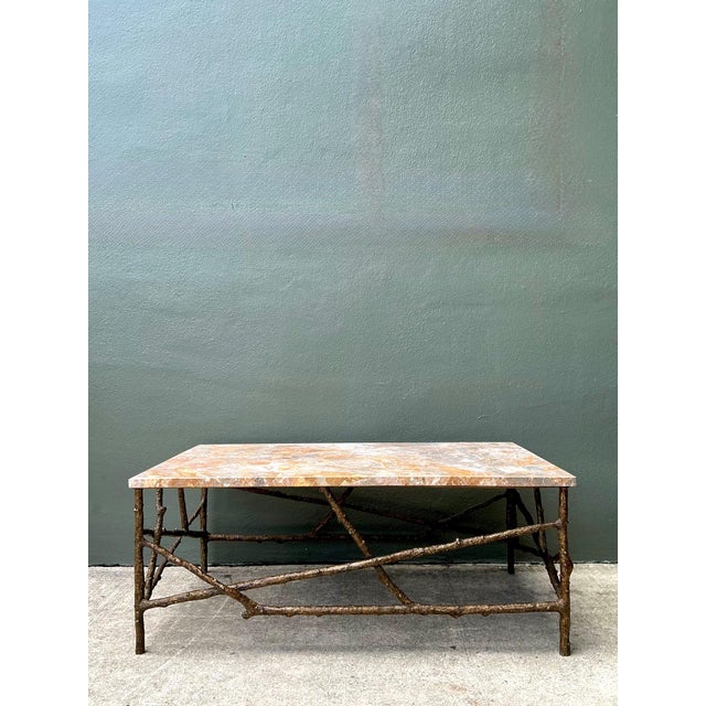 This vintage faux bois coffee table is a sophisticated blend of natural inspiration and sculptural design. The rectangular...
