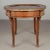 A French Louis XV style oval coffee table with marquetry veneer of mahogany and inset black marble top. Cast bronze...