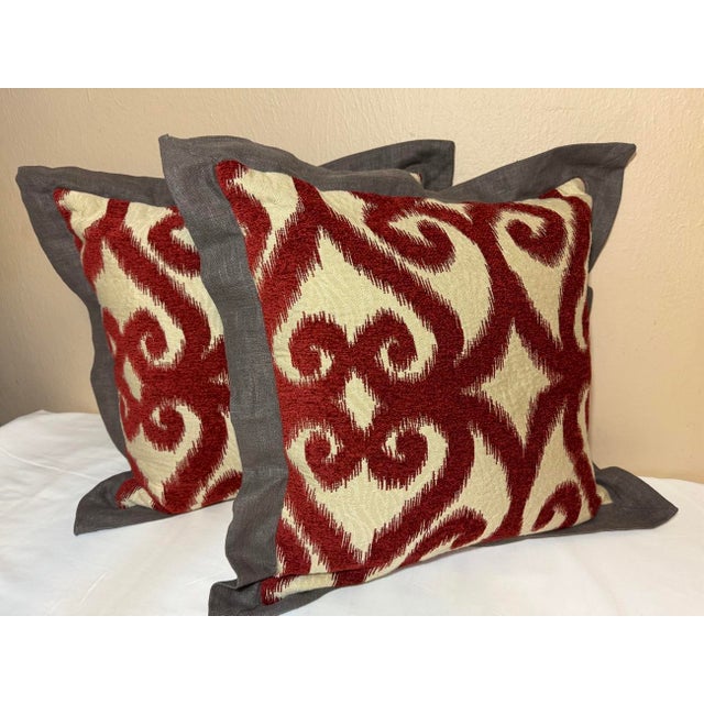 Pair of custom made pillows. The fabric is scroll patterned russet/brick red chenille with a beige ground that has a...