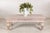 Crafted in teak with a heavily weathered whitewashed finish, this vintage coffee table features a substantial rustic...