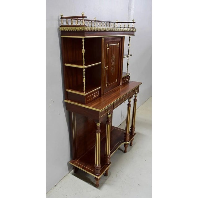 Solid mahogany and veneered cabinet, generously upholstered in brass, in the Louis XVI style. Although in one piece, we...