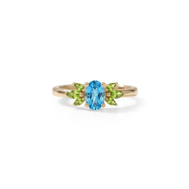 Embrace vibrant color and striking design with this beautifully crafted Oval Blue Topaz and Peridot Cluster Ring. At its...