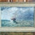 An oil on canvas seascape, English or American, depicting a ship balanced atop a large rough swell amid other big waves...