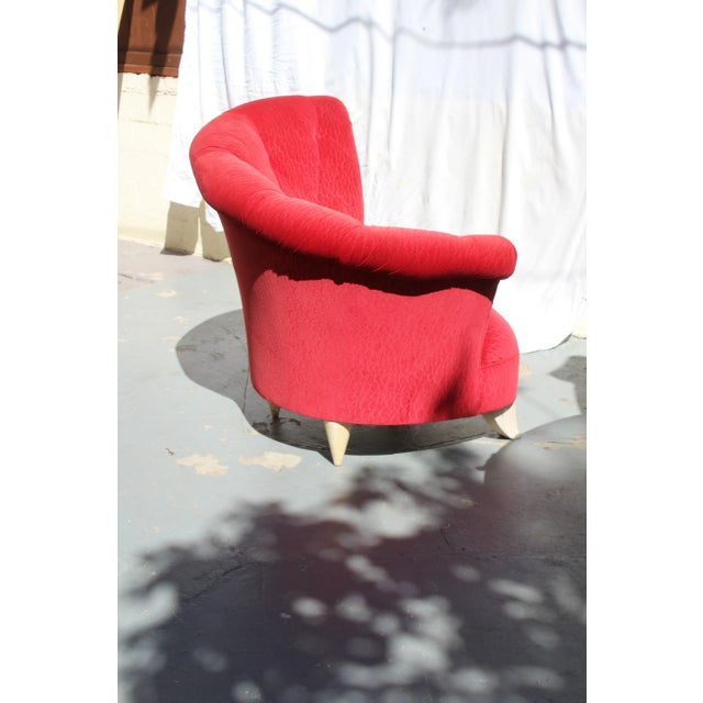 Modern Peter Shire-style lounge chair in ruby red with flared tufted back and white sabre feet.