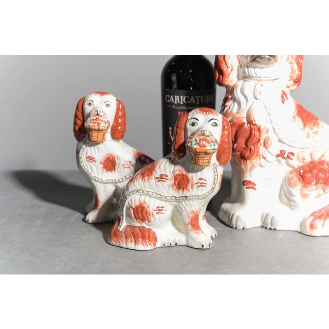 A charming and highly decorative grouping of three antique Staffordshire spaniel figures, including a larger King...
