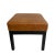 A pair of classic square low stools with cushions upholstered in handsome and mildly distressed brown leather. The solid...