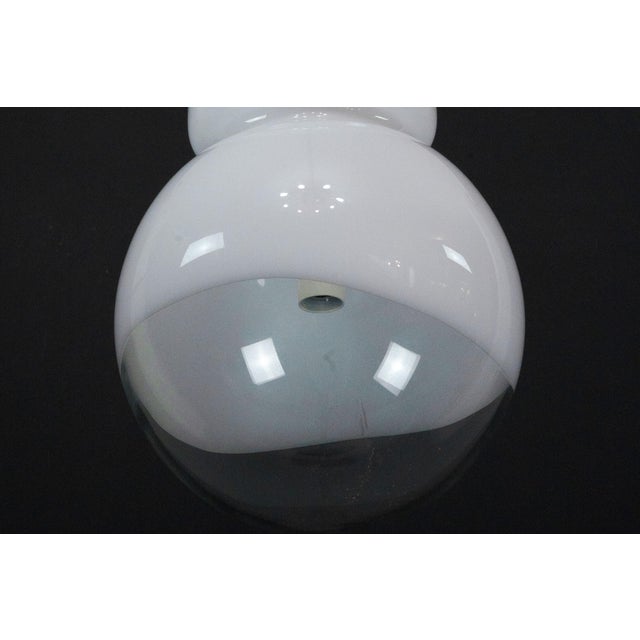 Space Age pendant chandelier by Mazzega, Italy, dating from the 1960s. Featuring a shade composed of white opaline Murano...