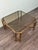 Vintage Hollywood Regency-style coffee table dating back to the 1960s or 1970s. The frame is made of brass, and the top is...