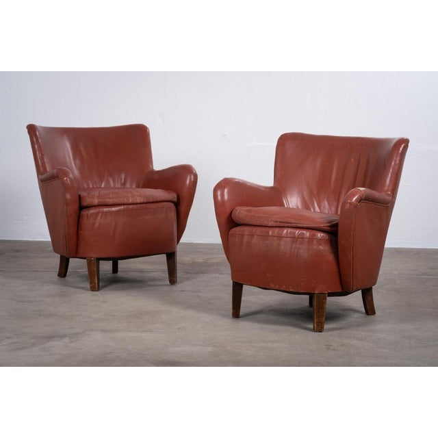 Elegant pair of Danish club chairs from the 1930s, showcasing beautiful proportions and timeless design. Upholstered in...