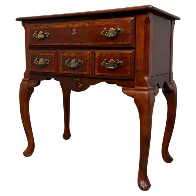 An elegant early 20th-century English side table, finely crafted from beech and distinguished by its decorative burr...