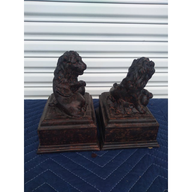 This is a nice pair of plaster cast bookends. They're cast in the shape of lions resting on stands reminiscent of of...