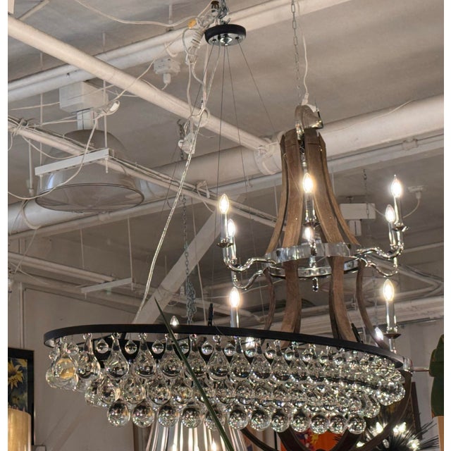 Design Plus Gallery presents the Arctic Pear Oval Chandelier by Ochre. The elongated metal framework has a blackened...