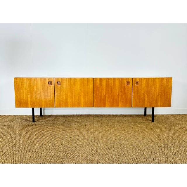 Magnificent vintage Scandinavian teak sideboard dating from the 1960s, featuring four storage doors with shelves. The...