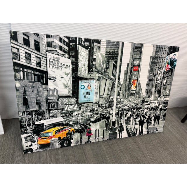 Design Plus Gallery presents a Photograph of Time Square in New York City. The panoramic cityscape captures the bustling...