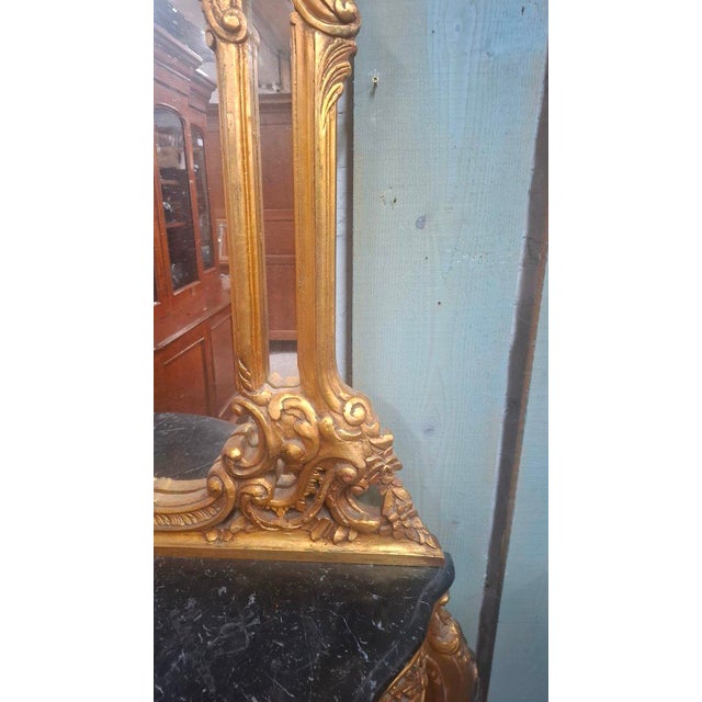 A Louis XV style console table with a marble top and mirror. Made in the 1970s. Period: 20th century Style: Louis XV -...