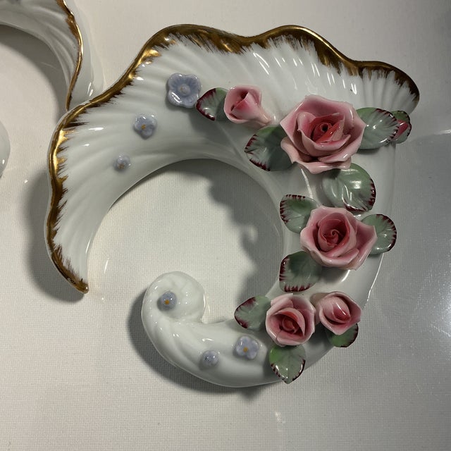 This item is a set of vintage porcelain cornucopia wall pocket vases decorated with applied pink roses, green leaves,...