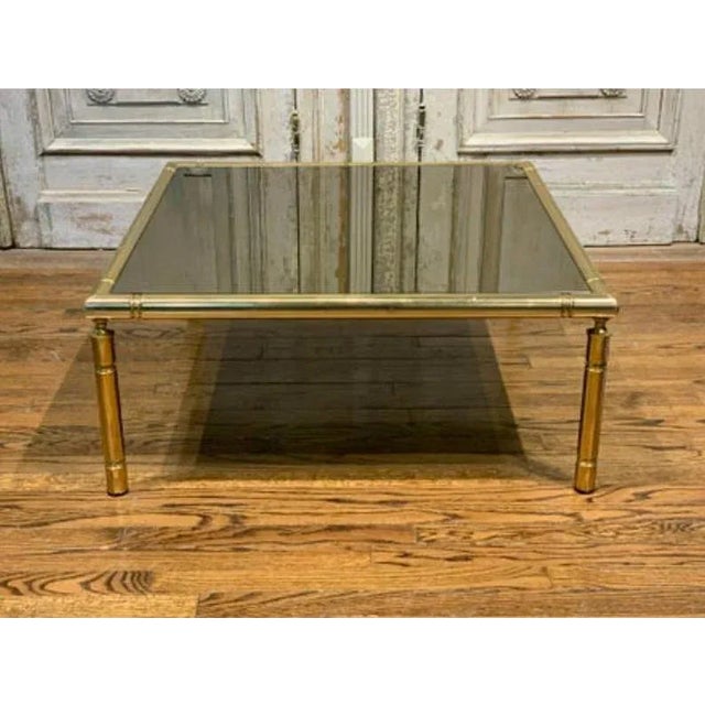 A large, square, French tubular polished brass table, circa 1960s/1970s. The vintage mid-century table has a base frame...