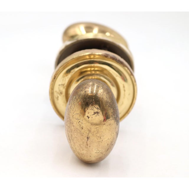 Reclaimed polished brass passage door knob set with oval knobs and concentric rosettes. The original mounting screws are...
