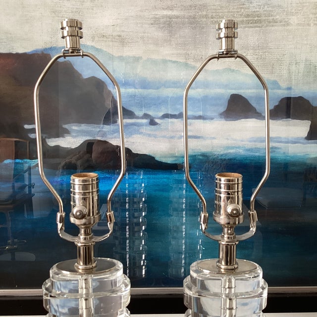 Elegant pair of table lamps by Visual Comfort, featuring vertically stacked solid glass disc columns set on polished...