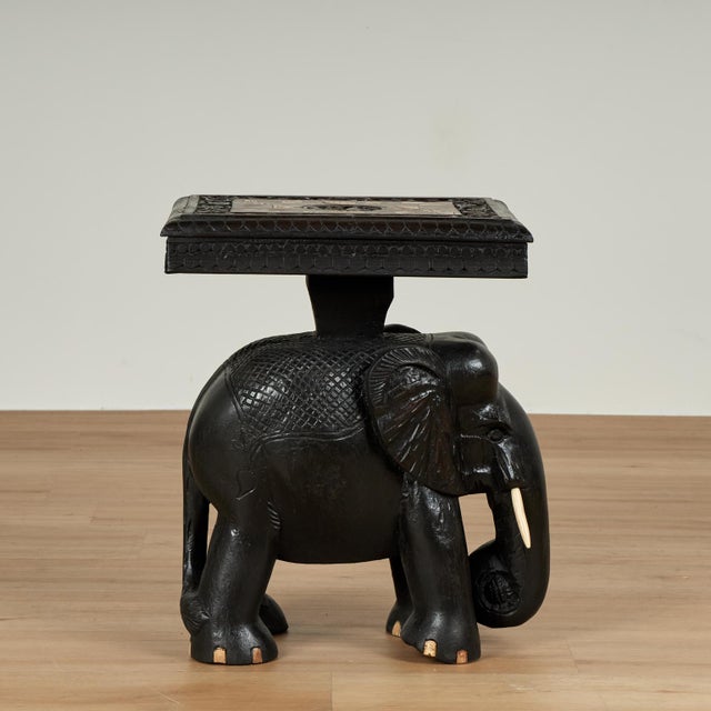 Impressive pair of antique Anglo Indian stands crafted in teak having tops with center carved elephants and inlaid bone...