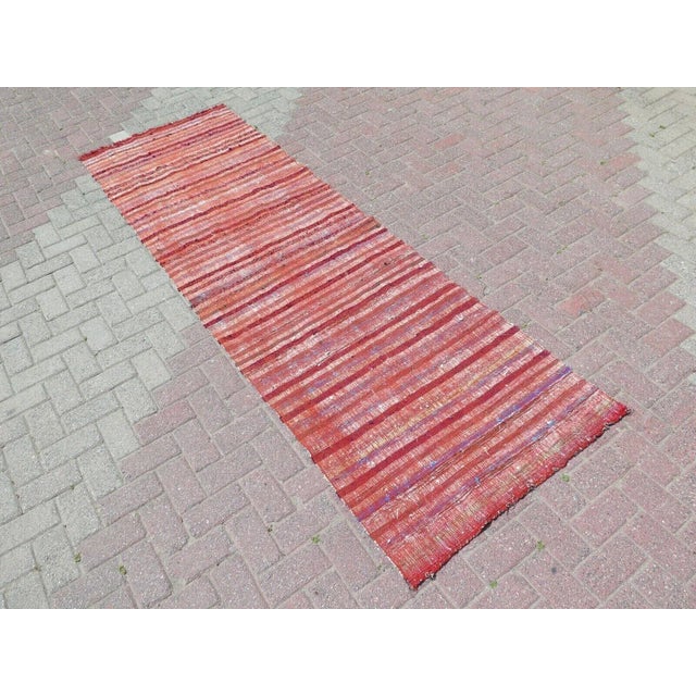 This beautiful, traditional vintage, flatweaved Turkish kilim rug is approximately 60 years old. It is handmade of very...