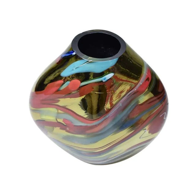 A unique glass, gold mirrored glass with abstract inclusion of yellow, red and blue and white. Murano Italy This piece has...