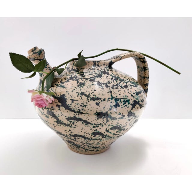 Made in Italy, 1950s. This vase is made in lacquered and hand painted terracotta with a decoration which is similar to the...