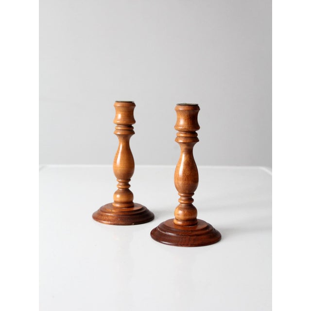 This pair of vintage turned wood candlestick holders reflects traditional American design, featuring softly contoured...