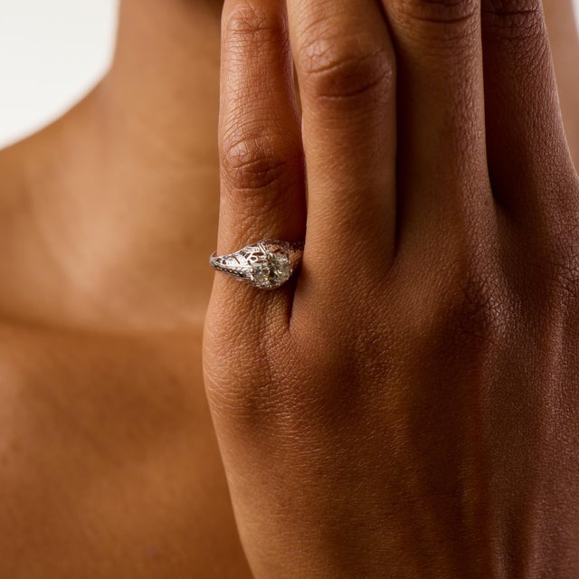 This elegant Art Deco engagement ring showcases a distinctive east west set 0.91 carat old mine cut diamond, certified by...