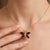 The wings are artfully adorned with four deep, rich, and lustrous natural garnet gemstones. The intense, fiery red hues of...