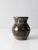 This is a vintage studio pottery vase. The handmade art vase features a hand-painted floral design with deep forest green...