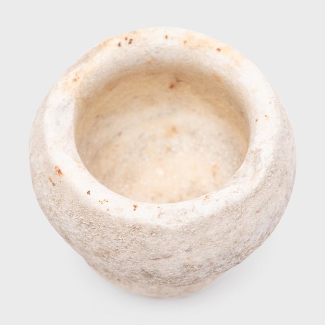 Hand-carved from a single block of marble, this original stone vessel is an antique Chinese mortar once used to grind...