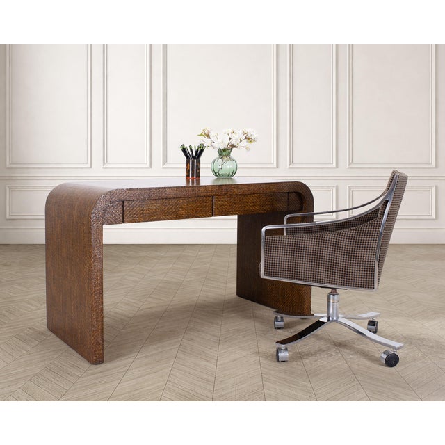 A stylish and iconic mid-century modern two-drawer waterfall form desk constructed out of oak and woven grasscloth in the...