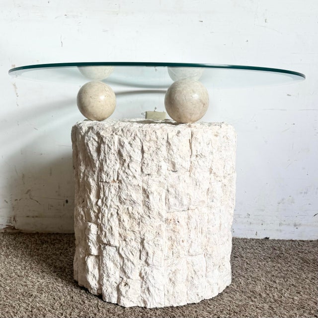This striking postmodern side table features a circular beveled glass top delicately balanced on tessellated stone...