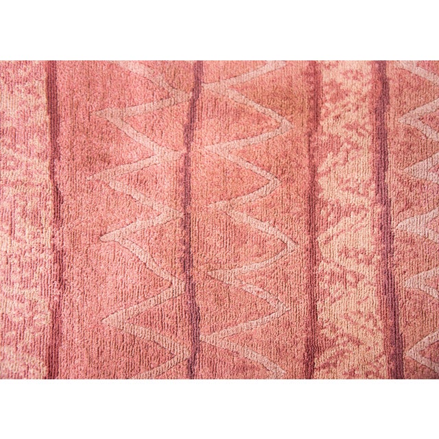 A vintage late 20th century Tibetan hand-knotted runner with a horizontal stripe pattern woven in varying shades of reds,...