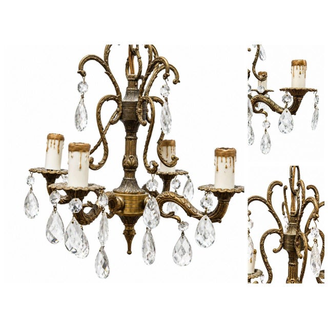 Dazzle your space with this captivating vintage-style crystal chandelier. Featuring an ornate aged metal frame, five...