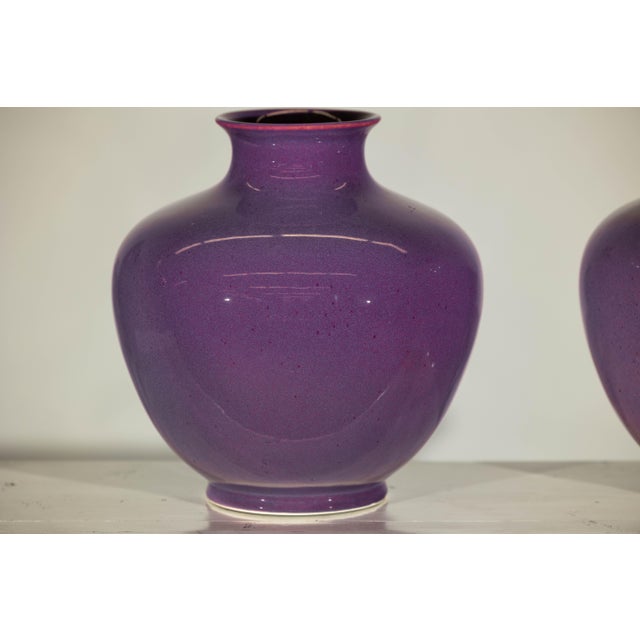 This exquisite pair of purple ceramic vases combines timeless elegance with contemporary charm. Their rounded bellies and...