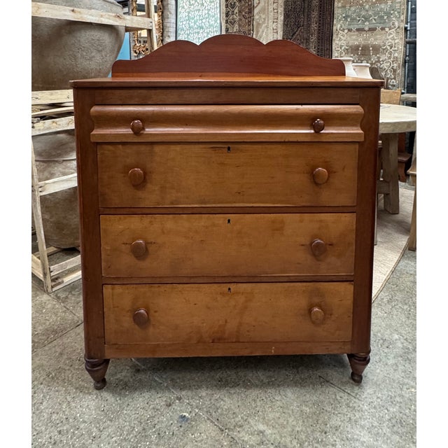 Dating to approximately the 1860s–1880s, this mid-19th century cherry dresser features five drawers, including a hand-...